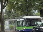 A bus stopping to pick up people on their way home