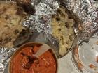 Delicious buttered chicken with rice and a side of naan!