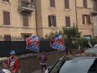 The Contrada of Pantera waves their red, blue and white flags to represent their neighborhood district