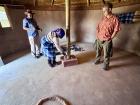 Inside an African hut, the walls are made of mud and cow dung, the roof is made of reeds. The circle on the ground is where you would start a fire and cook your meals.