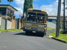 A bus passing through the neighborhood