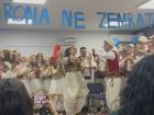 My students reenacting a traditional Albanian wedding, with the bride wearing red face covering, the groom holding a red handkerchief and students throwing money