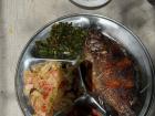 Whole fried fish, vegetables, nshima on the side
