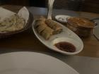 This is from left to right: garlic naan, chicken spring rolls, and butter chicken