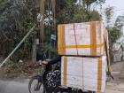 People carry big boxes or deliveries on their motorbikes