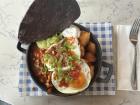 Tex-Mex eggs with potatoes, beans and toppings from a brunch place called Caprice in Galway