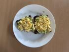A homemade breakfast of avocado toast and eggs