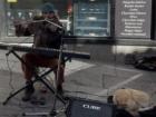 A flute player in Toledo accompanied by their dog