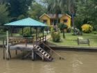 In Buenos Aires, many houses are built right next to the river, the brown water flows underneath docks and homes like this one, and people often travel by boat to get around the area