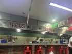 Inside Tacos San Burgos—the sizzling sound and smell of tacos being made fill the air as you watch each one come to life