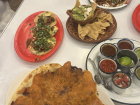 Enjoying guacamole, tacos and a crispy costra al pastor at Tacos La Chula with friends