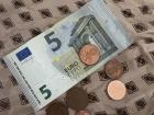 A snapshot of a five euro bill and change