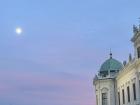The moon during sunset from the gardens of the Upper Beldevere Palace in Vienna, Austria