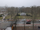 This image taken from a classroom window shows both the typical roadway through town and a peak at the train station through the trees in the back.