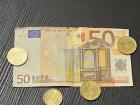 A 50 euro note and some coins