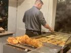 Man frying Reibekuchen (the German equivalent to latkes) at a Stall in the Mainz Christmas Market
