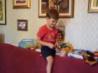 Dominik plays with his toys in the living room