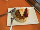 Chorizo (spicy pork sausage) pintxo on bread topped with an egg