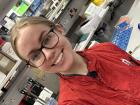 Me wearing a lab coat and smiling through a long day of lab work