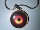 I have a necklace depicting the photo taken in 2022 of the supermassive black hole at the center of our galaxy!