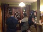 Family photo inside Paulina's house of a game of darts