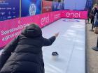 Trying out curling at the Fan Village