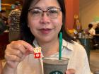 This is my mom with her Starbucks and a little chocolate that has SG60 (for Singapore's 60th birthday)