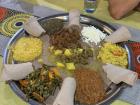 Traditional Ethiopian food at Seble, a garden restaurant where Ethiopian music plays constantly. Meals are served on injera, a soft fermented flatbread.