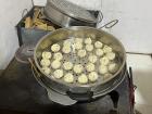 Making buuz (Mongolian dumplings) in the steamer for a lot of people.