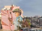 You can see, not only the mural on this building, but also the water storage tanks on the roof