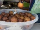 Makoenya, also know as fat cakes, fresh out of the fryer and sold at a shop in town