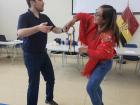 Sam and a teacher dancing at the training we hosted