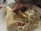 The most traditional Paraguayan meal, asado, pictured here with roasted pork ribs, coleslaw and boiled mandioca