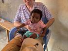 This is a picture of me holding baby Amara! When I visited the local clinic, Amara was being weighed and receiving vaccinations--she did not like the shots, but she liked it when I held her