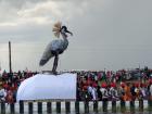 The queen's canoe has an egret on top, and the wings move up and down