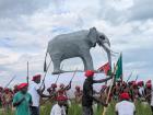 The king's canoe has an elephant riding on top