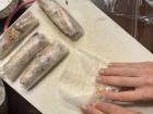 This is the process of rolling the nem rán in the rice paper wrappers