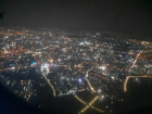 City lights of Hồ Chí Minh City shine below, as my plane flies at night