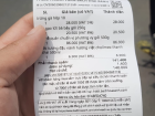 My grocery receipt shows ten eggs, brown rice noodles, coffee and soy sauce—the ten eggs cost 28,000 VND (about $1.07 USD)