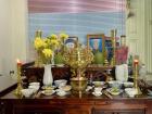 Photos of Hà’s grandparents displayed on the family altar with offerings of flowers, fruit, food and incense for cúng