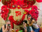 Volunteers Hali, Ila and I pose in front of a colorful Tết holiday display