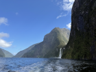 More of the gorgeous natural sights of New Zealand, a waterfall coming down from a valley carved by glaciers in Milford Sound