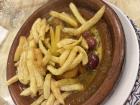 This is chicken and olives cooked in a tajine and topped with fries