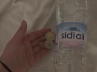 This large bottle of water costs six dirhams, which equals the coins I'm holding