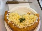 Lángos, a traditional Hungarian food found at market halls, street vendors, and festivals.