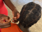 Showing off her hair braiding skills