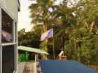 The Belizean flag outside the window, flying proud