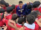 The boys soccer team saying a prayer before one of their games