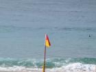 A red and yellow flag marks a swimming zone, and is a symbol of Australian beach culture.