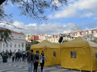 A candid view of the square during the event, with colorful buildings and tents in the background.